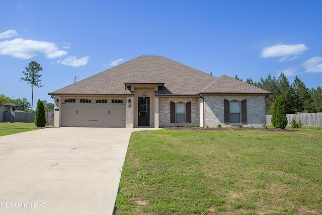 163 Frye Cir, Caledonia, MS 39740 - french country style house with driveway, a garage, and roof with shingles