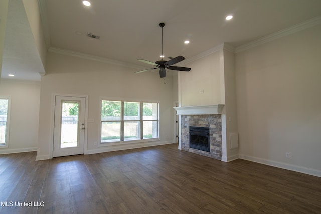 163 Frye Cir, Caledonia, MS 39740 - unfurnished living room with plenty of natural light, dark wood-style flooring, a stone fireplace, ornamental molding, and recessed lighting