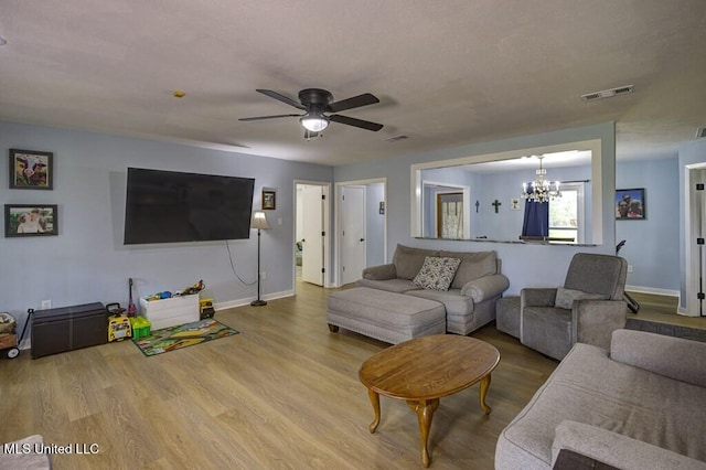5285 Williamson Rd, Clinton, MS 39056 - living room with a chandelier, wood finished floors, and a ceiling fan