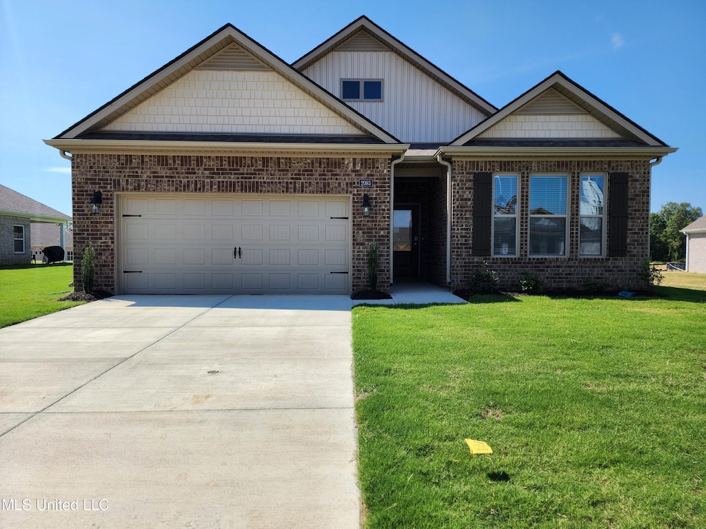 view of front of home featuring a garage and a front yard