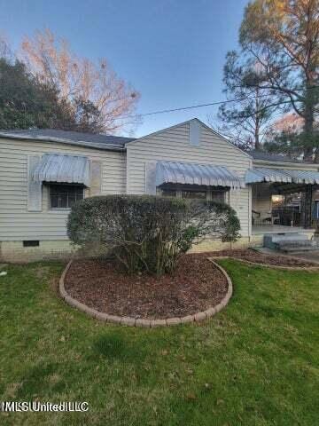 view of property exterior featuring a lawn