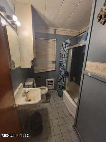 full bathroom featuring toilet, shower / bath combination with glass door, and sink