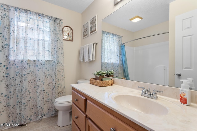 bathroom with curtained shower, tile patterned flooring, a textured ceiling, toilet, and vanity