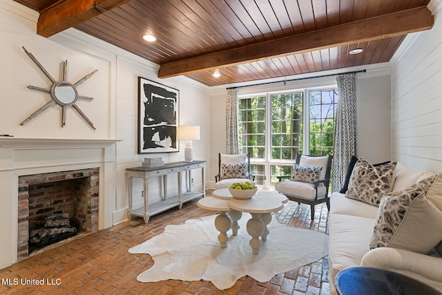 sitting room with beamed ceiling, crown molding, and wood ceiling