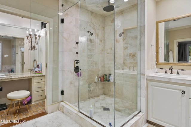 bathroom featuring vanity, a chandelier, and a shower with door