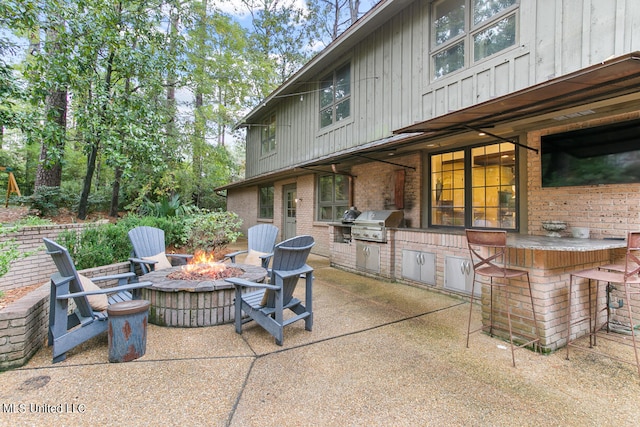 view of patio / terrace with area for grilling and an outdoor fire pit