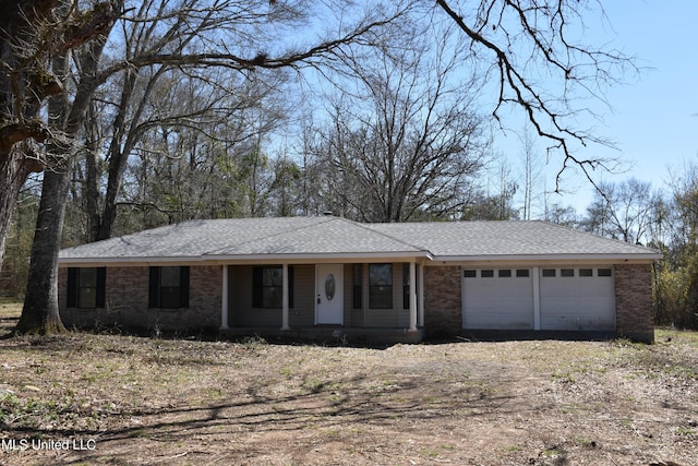 ranch-style home with an attached garage, brick siding, driveway, and roof with shingles