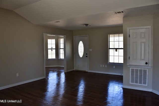 foyer entrance featuring dark wood-type flooring, baseboards, and visible vents