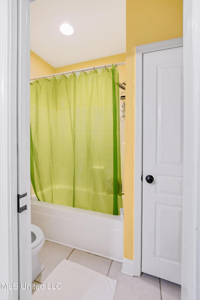 bathroom featuring toilet, tile patterned flooring, and shower / tub combo