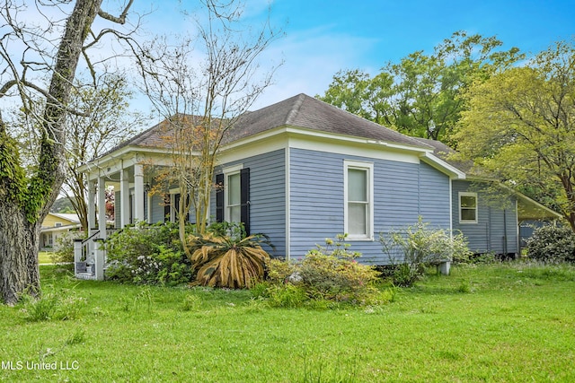 view of home's exterior featuring a lawn and roof with shingles
