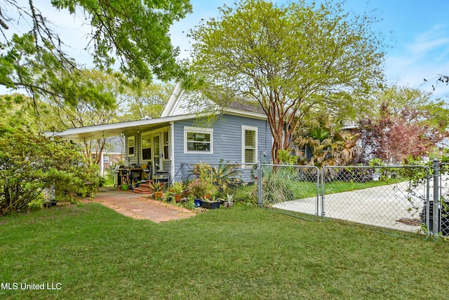 rear view of house with a gate, fence, and a lawn