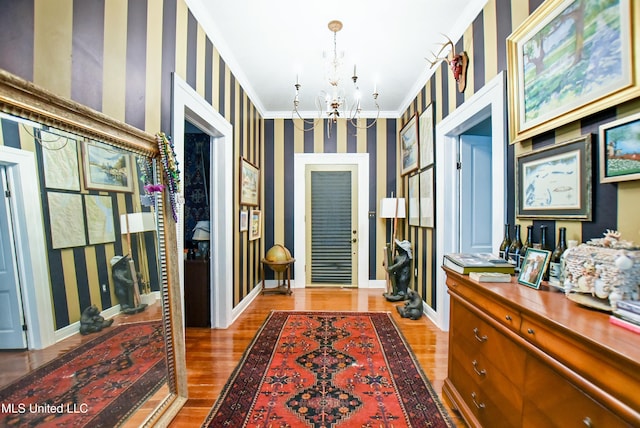 spacious closet with a notable chandelier and wood finished floors