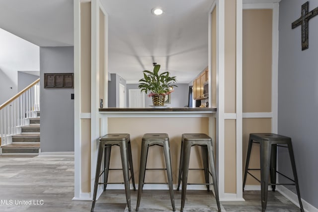 11222 Cypress Bayou Dr, Gulfport, MS 39503 - bar featuring stairs, wood finished floors, and baseboards