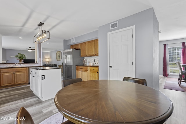 11222 Cypress Bayou Dr, Gulfport, MS 39503 - dining space with visible vents, recessed lighting, ceiling fan with notable chandelier, and light wood-style floors
