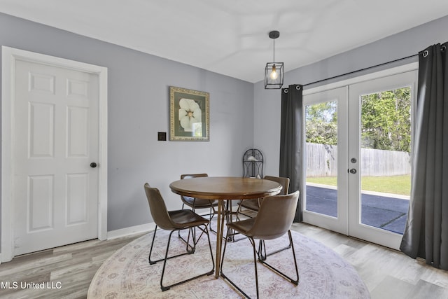11222 Cypress Bayou Dr, Gulfport, MS 39503 - dining space featuring french doors, baseboards, and light wood-style floors