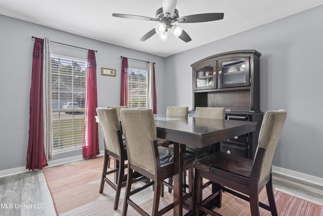 11222 Cypress Bayou Dr, Gulfport, MS 39503 - dining area with light wood-style floors, a ceiling fan, and baseboards