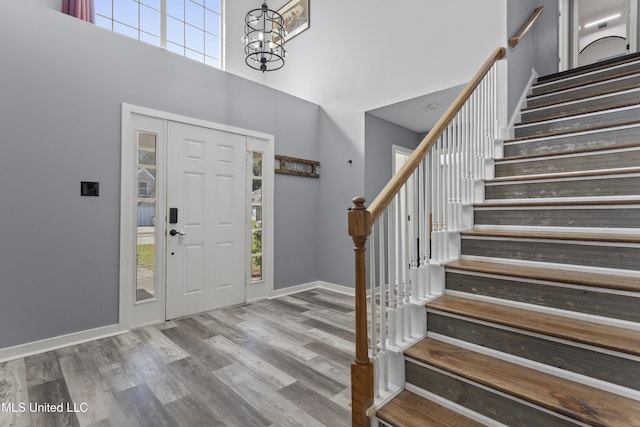 11222 Cypress Bayou Dr, Gulfport, MS 39503 - foyer entrance featuring a chandelier, stairs, baseboards, a towering ceiling, and wood finished floors