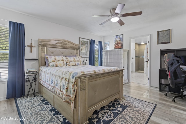 11222 Cypress Bayou Dr, Gulfport, MS 39503 - bedroom featuring ensuite bathroom, ceiling fan, and light wood-style floors