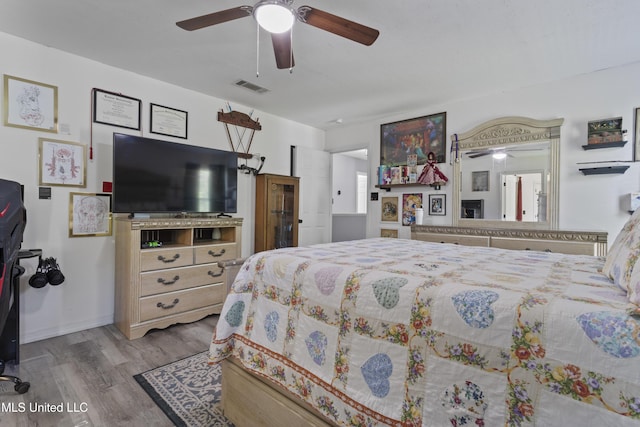 11222 Cypress Bayou Dr, Gulfport, MS 39503 - bedroom with baseboards, visible vents, wood finished floors, and ceiling fan