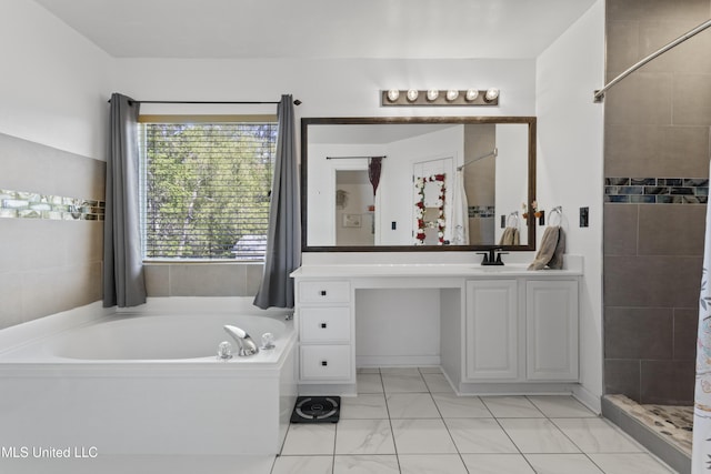 11222 Cypress Bayou Dr, Gulfport, MS 39503 - full bath with a garden tub, vanity, marble finish floor, and tiled shower