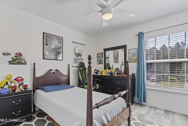 11222 Cypress Bayou Dr, Gulfport, MS 39503 - bedroom featuring baseboards, wood finished floors, a ceiling fan, and multiple windows