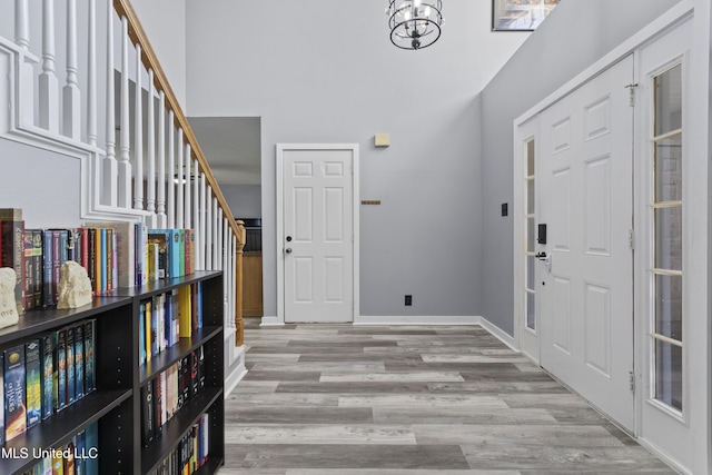 11222 Cypress Bayou Dr, Gulfport, MS 39503 - entrance foyer with a high ceiling, a chandelier, stairs, baseboards, and wood finished floors