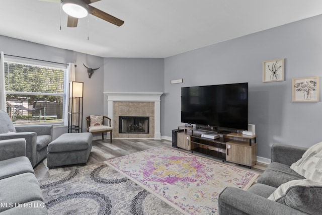 11222 Cypress Bayou Dr, Gulfport, MS 39503 - living area featuring baseboards, wood finished floors, a ceiling fan, and a tile fireplace