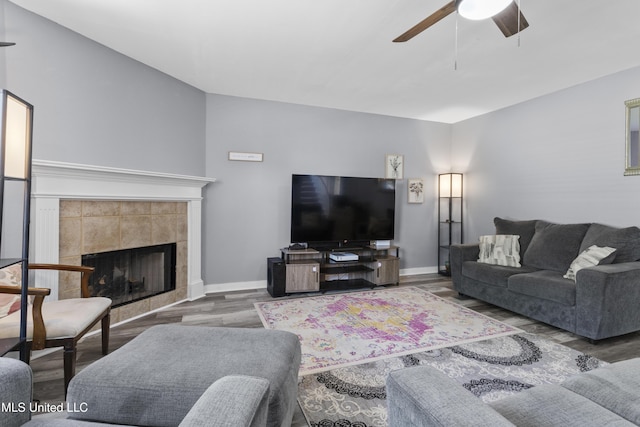 11222 Cypress Bayou Dr, Gulfport, MS 39503 - living area featuring baseboards, wood finished floors, a ceiling fan, and a tiled fireplace