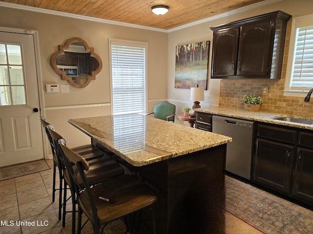 447 Shaker Dr, Senatobia, MS 38668 - kitchen featuring wainscoting, a sink, dark brown cabinets, dishwasher, and a kitchen bar