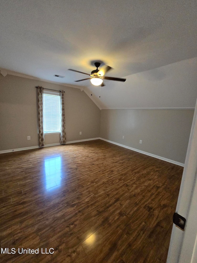 447 Shaker Dr, Senatobia, MS 38668 - additional living space with lofted ceiling, ceiling fan, dark wood-style flooring, visible vents, and baseboards