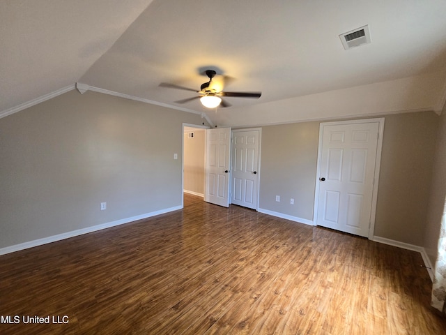 447 Shaker Dr, Senatobia, MS 38668 - unfurnished bedroom featuring visible vents, vaulted ceiling, baseboards, and wood finished floors