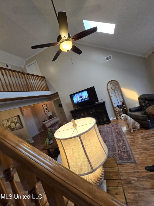 447 Shaker Dr, Senatobia, MS 38668 - living area featuring high vaulted ceiling, wood finished floors, visible vents, and crown molding