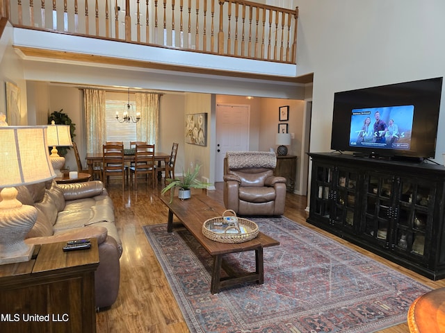 447 Shaker Dr, Senatobia, MS 38668 - living room featuring a high ceiling, wood finished floors, and a notable chandelier