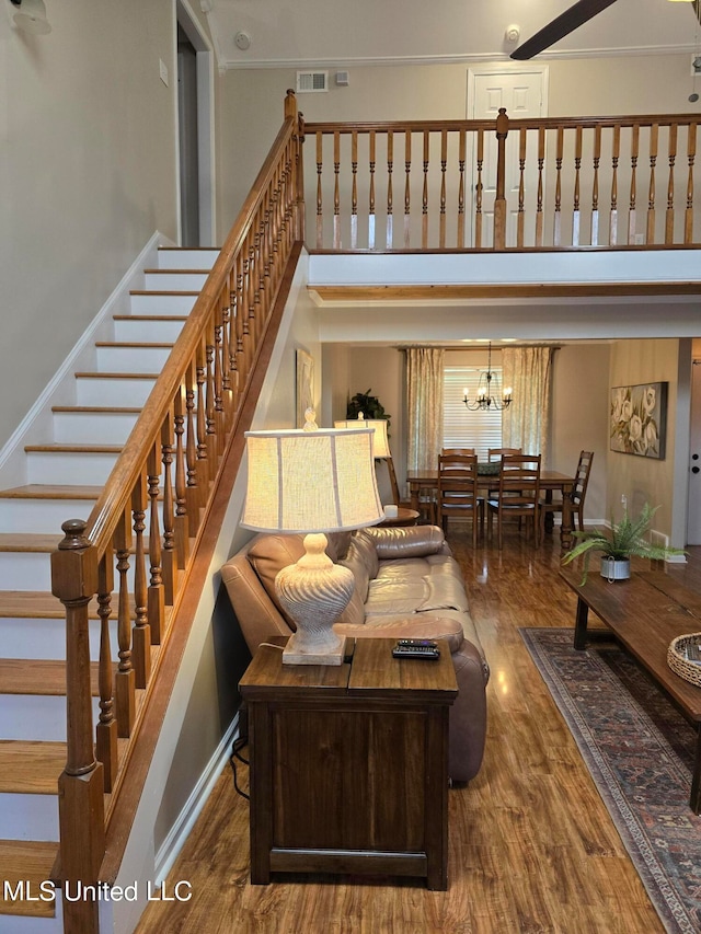 447 Shaker Dr, Senatobia, MS 38668 - living room with stairs, visible vents, wood finished floors, and a towering ceiling