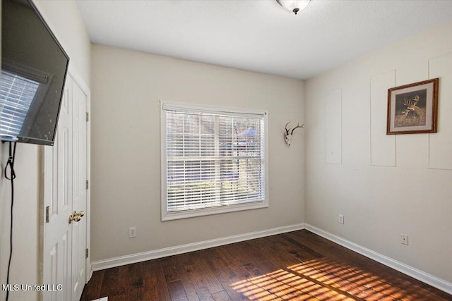 spare room with dark hardwood / wood-style floors