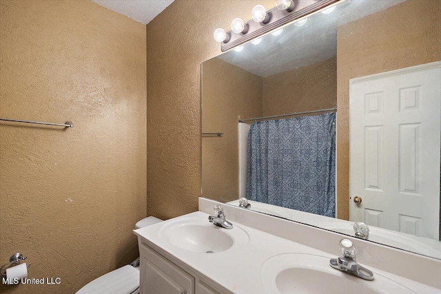 bathroom with a shower with curtain, vanity, and toilet