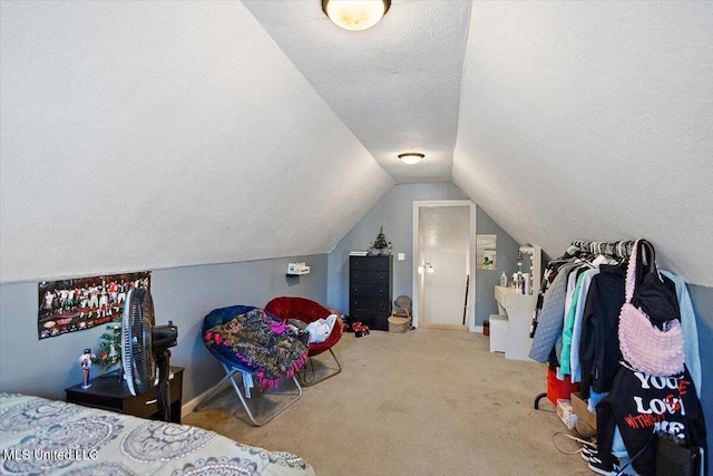 carpeted bedroom featuring a textured ceiling and vaulted ceiling