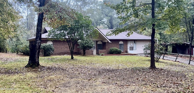 single story home with a front yard and a garage