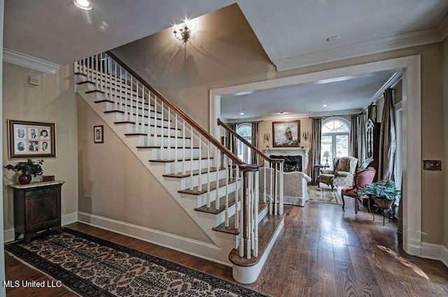 stairs featuring crown molding and wood-type flooring