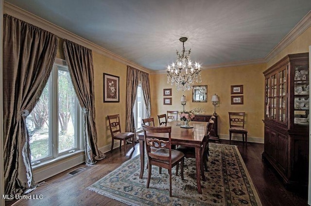 dining room featuring a wealth of natural light, ornamental molding, dark wood-type flooring, and an inviting chandelier