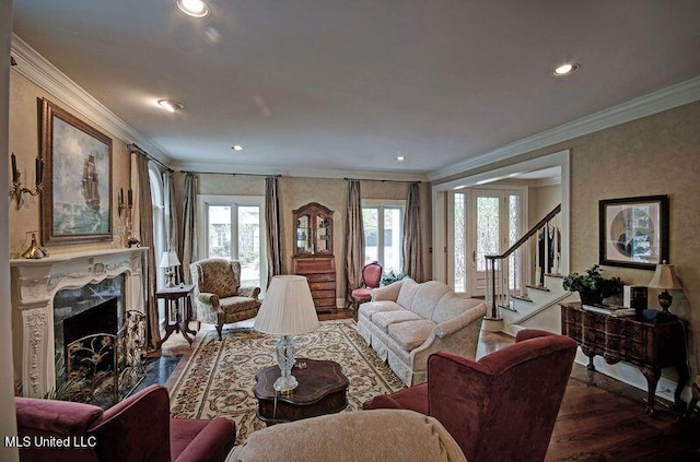 living room featuring ornamental molding, hardwood / wood-style floors, and a fireplace