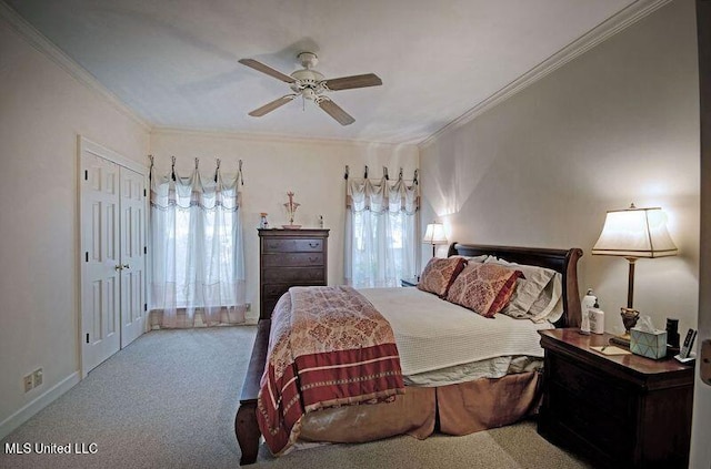 carpeted bedroom with crown molding, a closet, and ceiling fan