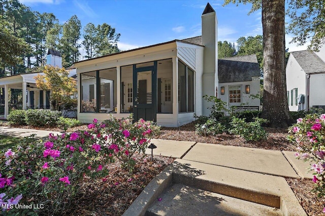 back of house with a sunroom