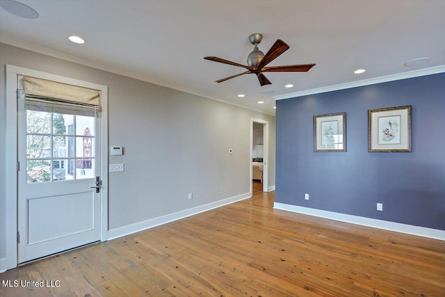 empty room featuring ornamental molding, light hardwood / wood-style floors, and ceiling fan