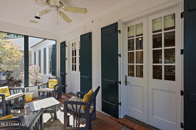 sunroom / solarium featuring ceiling fan