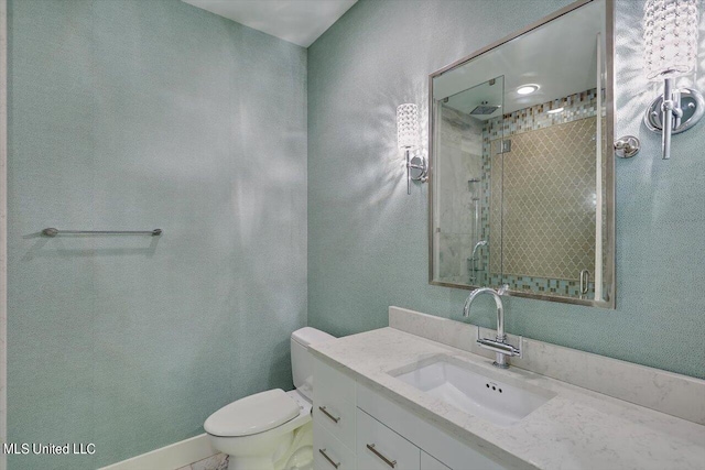 bathroom featuring toilet, vanity, and tiled shower