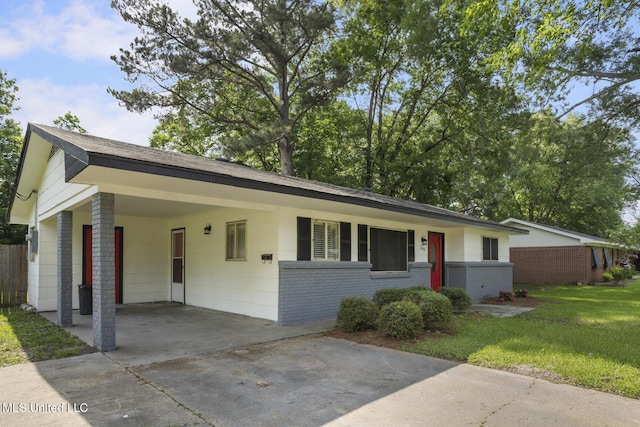 146 Greer Dr, Pearl, MS 39208 - single story home featuring brick siding, concrete driveway, an attached carport, and roof with shingles