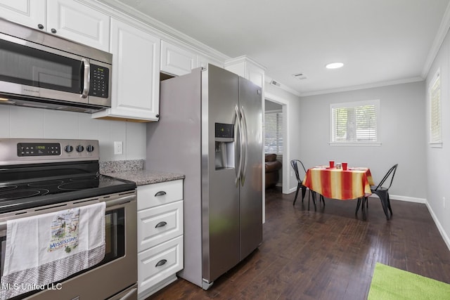 146 Greer Dr, Pearl, MS 39208 - kitchen with appliances with stainless steel finishes, ornamental molding, dark wood finished floors, white cabinetry, and baseboards
