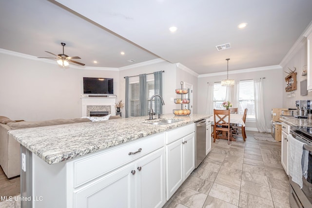 kitchen with pendant lighting, crown molding, a kitchen island with sink, stainless steel appliances, and white cabinets