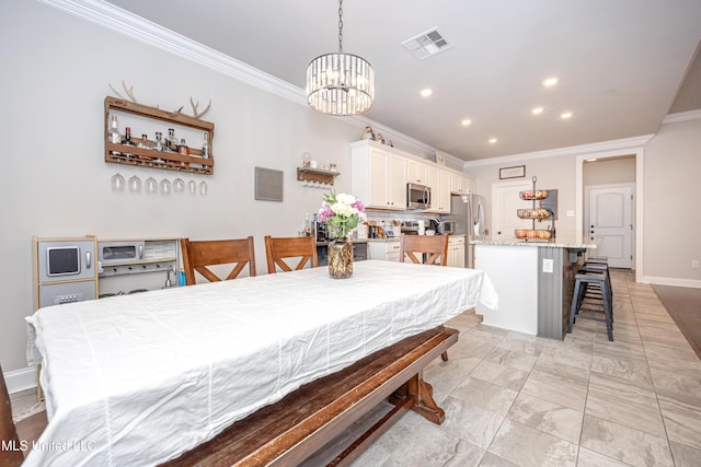 dining space with ornamental molding and an inviting chandelier